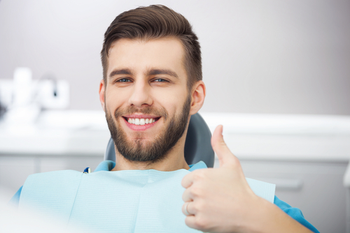 man smiling after multi-tooth implants